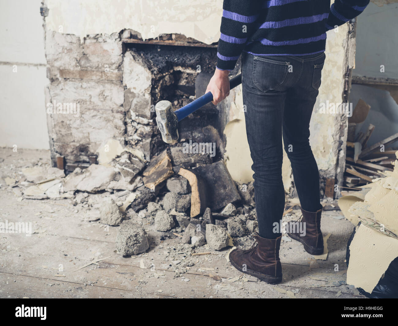 A Young Woman Is Opening Up An Old Fireplace In A Victorian House