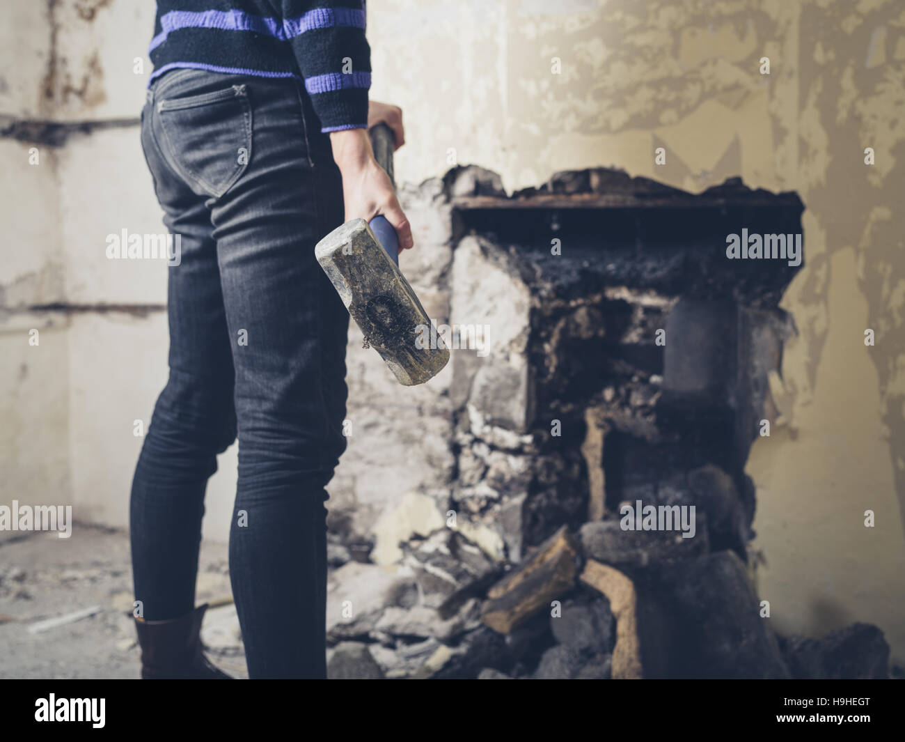 A Young Woman Is Opening Up An Old Fireplace In A Victorian House