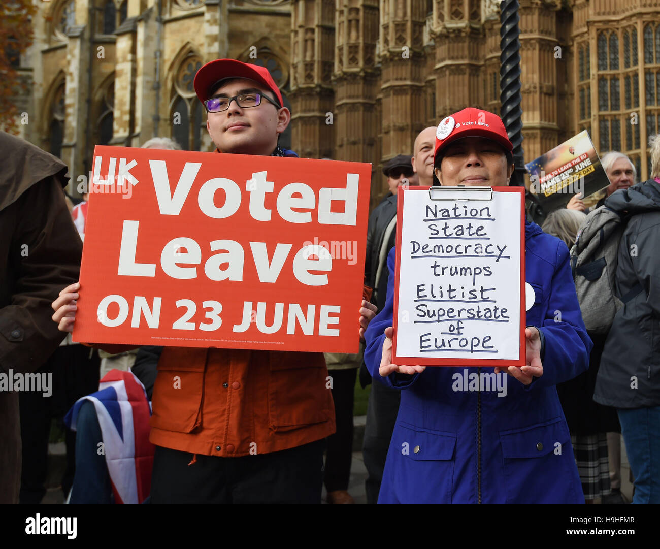 Leon (left) and Rita hold signs during a Pro Brexit protest outside the houses of Parliament in Westminster, London. Stock Photo