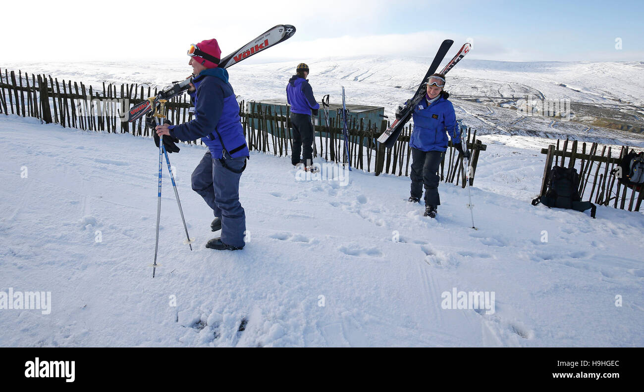 Skiers head uphill at Yad Moss ski slope in the North Pennines on the resort's first day of skiing and boarding of the season. Stock Photo