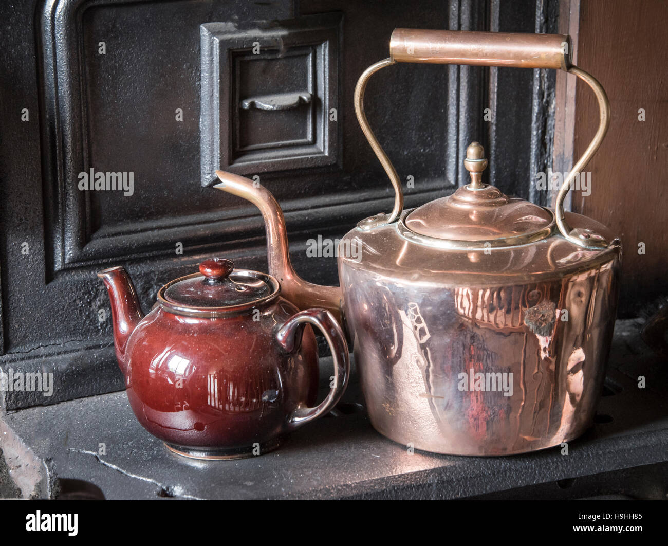Polished copper kettle and teapot on old range Stock Photo Alamy