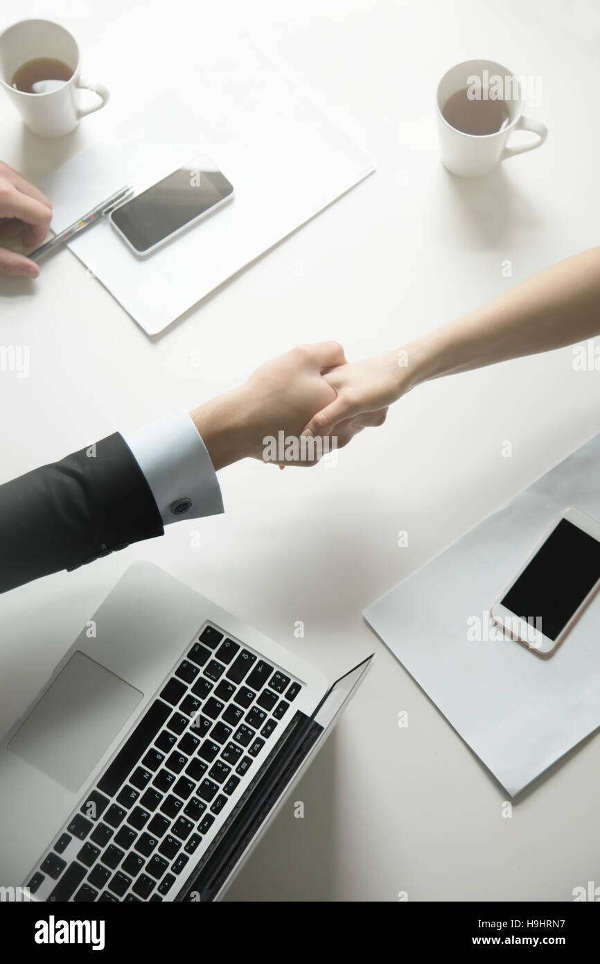 Top view of a strong handshake between man and woman Stock Photo