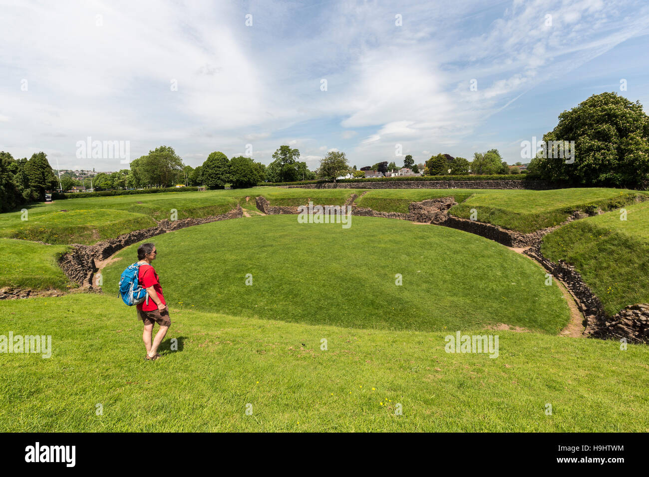 Woman looking at Caerleon Roman amphitheatre, Wales, UK Stock Photo