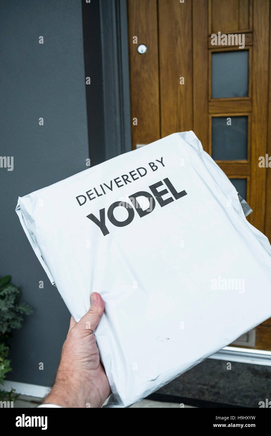 A parcel delivery to a house by Yodel. Stock Photo