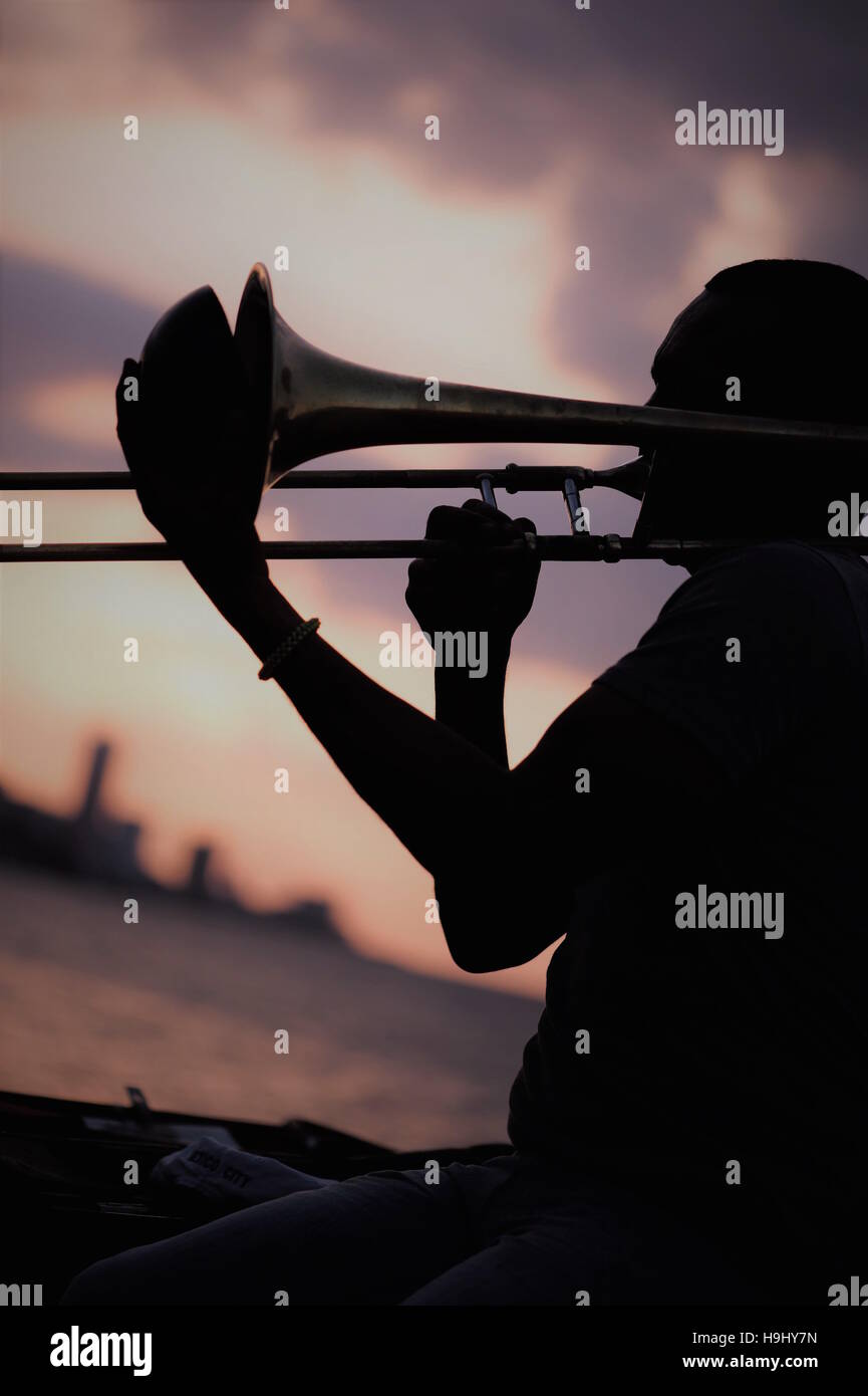 Man playing the trombone at sundown in Havana, Cuba Stock Photo Alamy