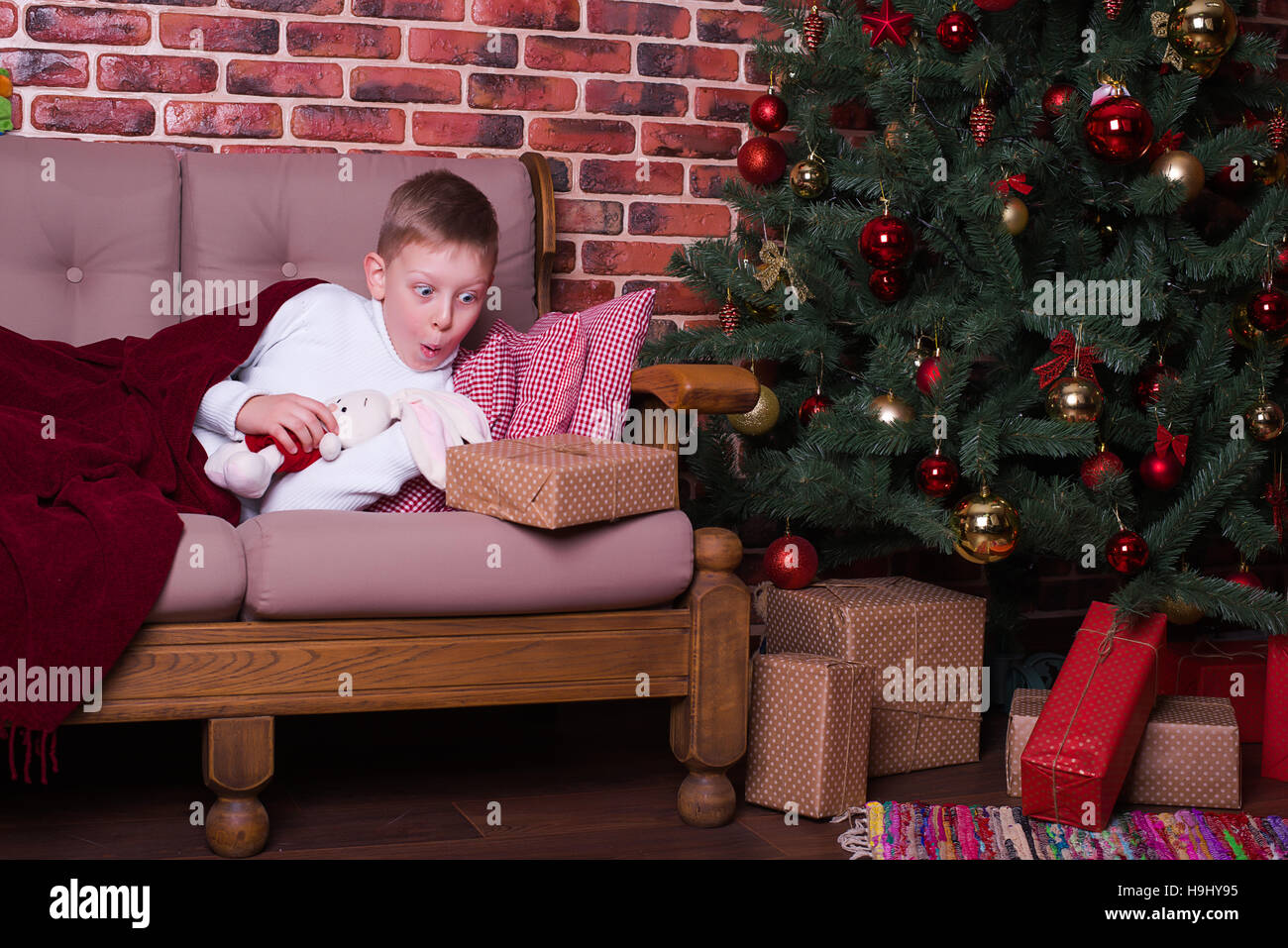 The boy woke up and surprised Christmas present Stock Photo
