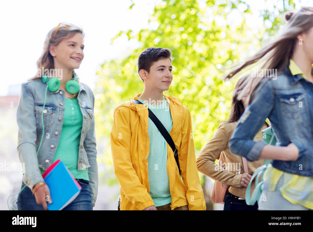 group of happy teenage students walking outdoors Stock Photo - Alamy