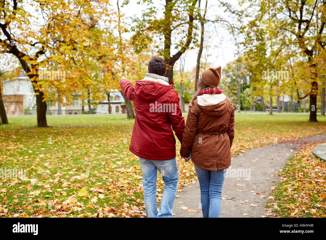 happy young couple walking in autumn park Stock Photo - Alamy
