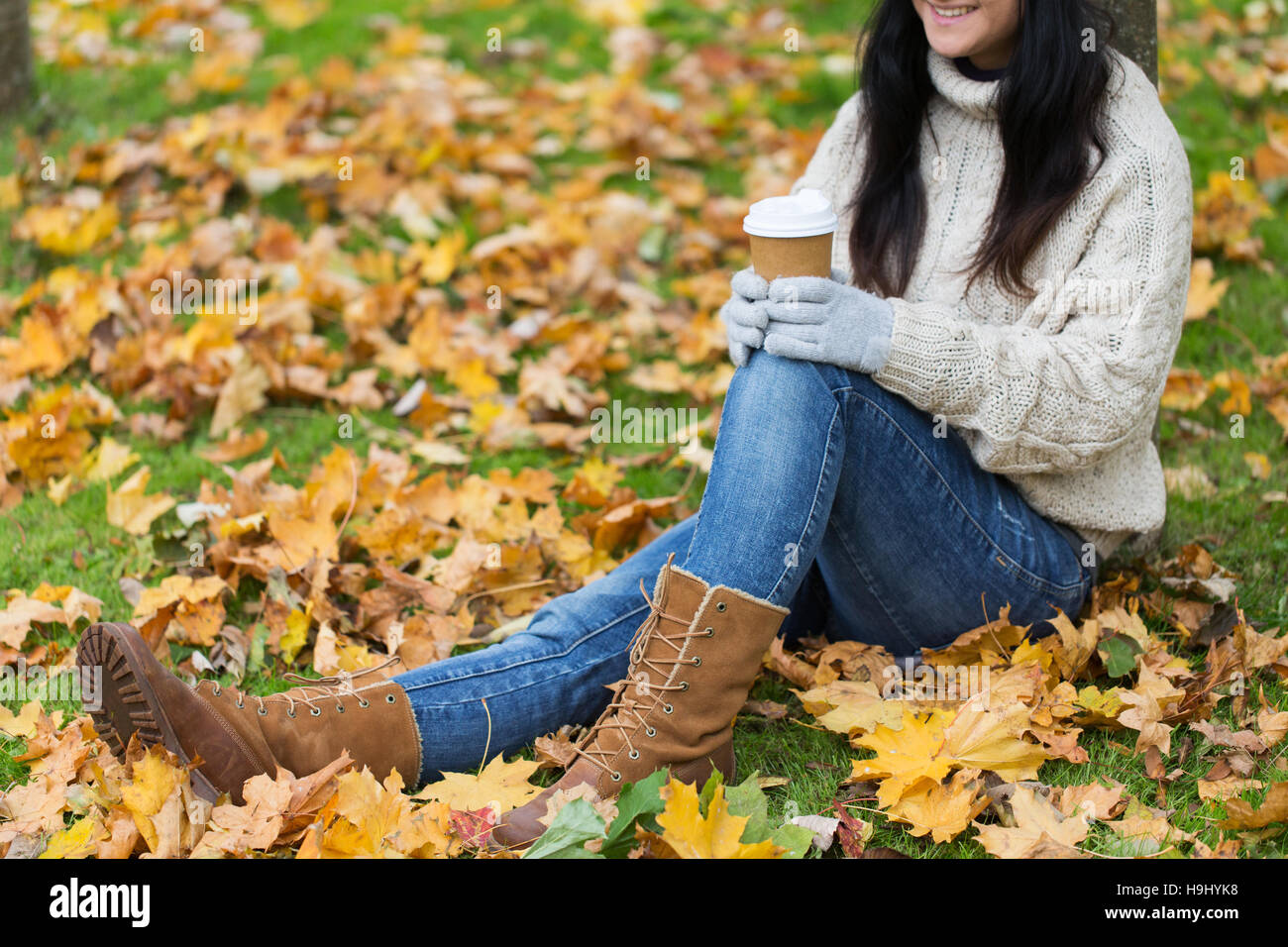 close up of woman drinking coffee in autumn park Stock Photo - Alamy