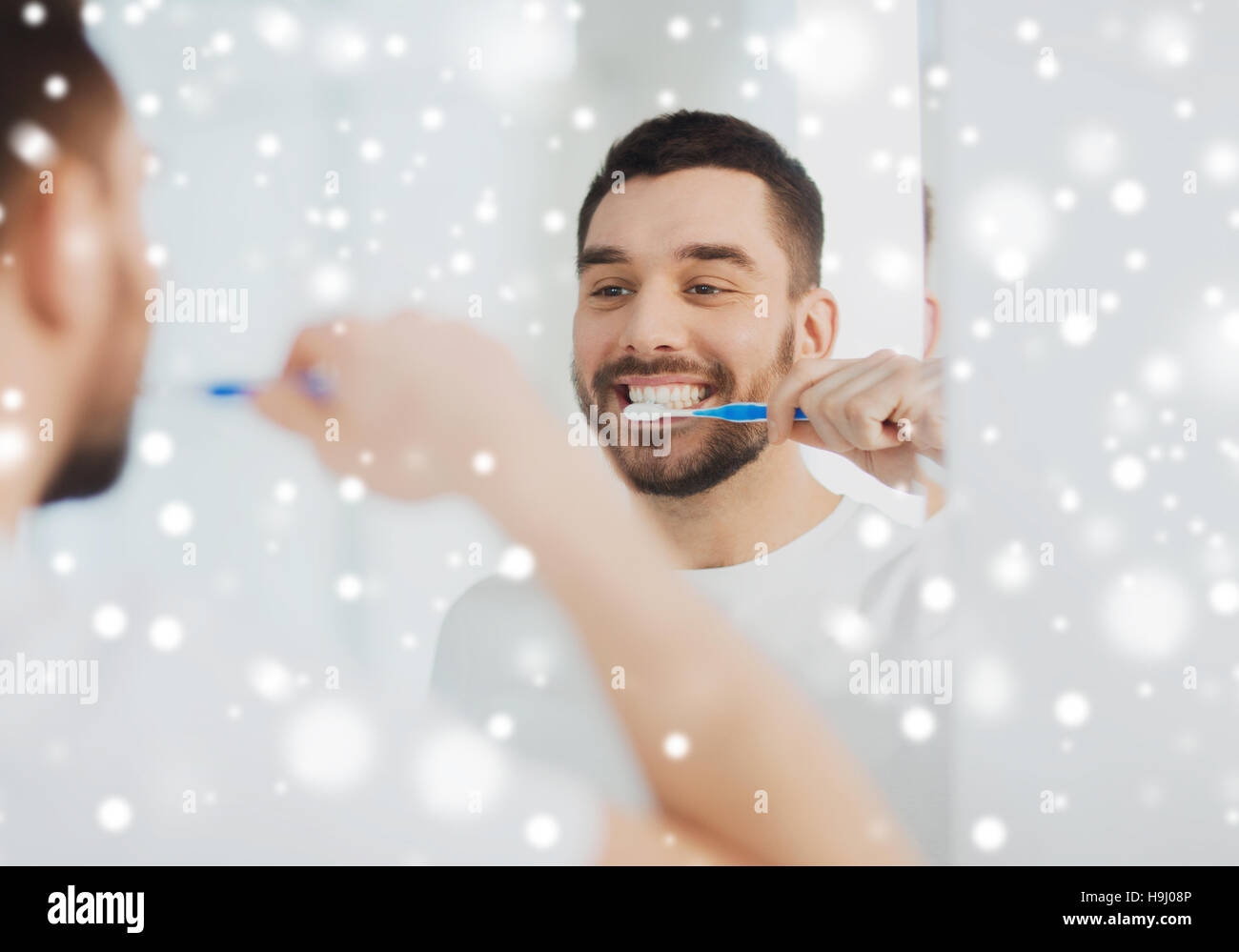 man with toothbrush cleaning teeth at bathroom Stock Photo Alamy