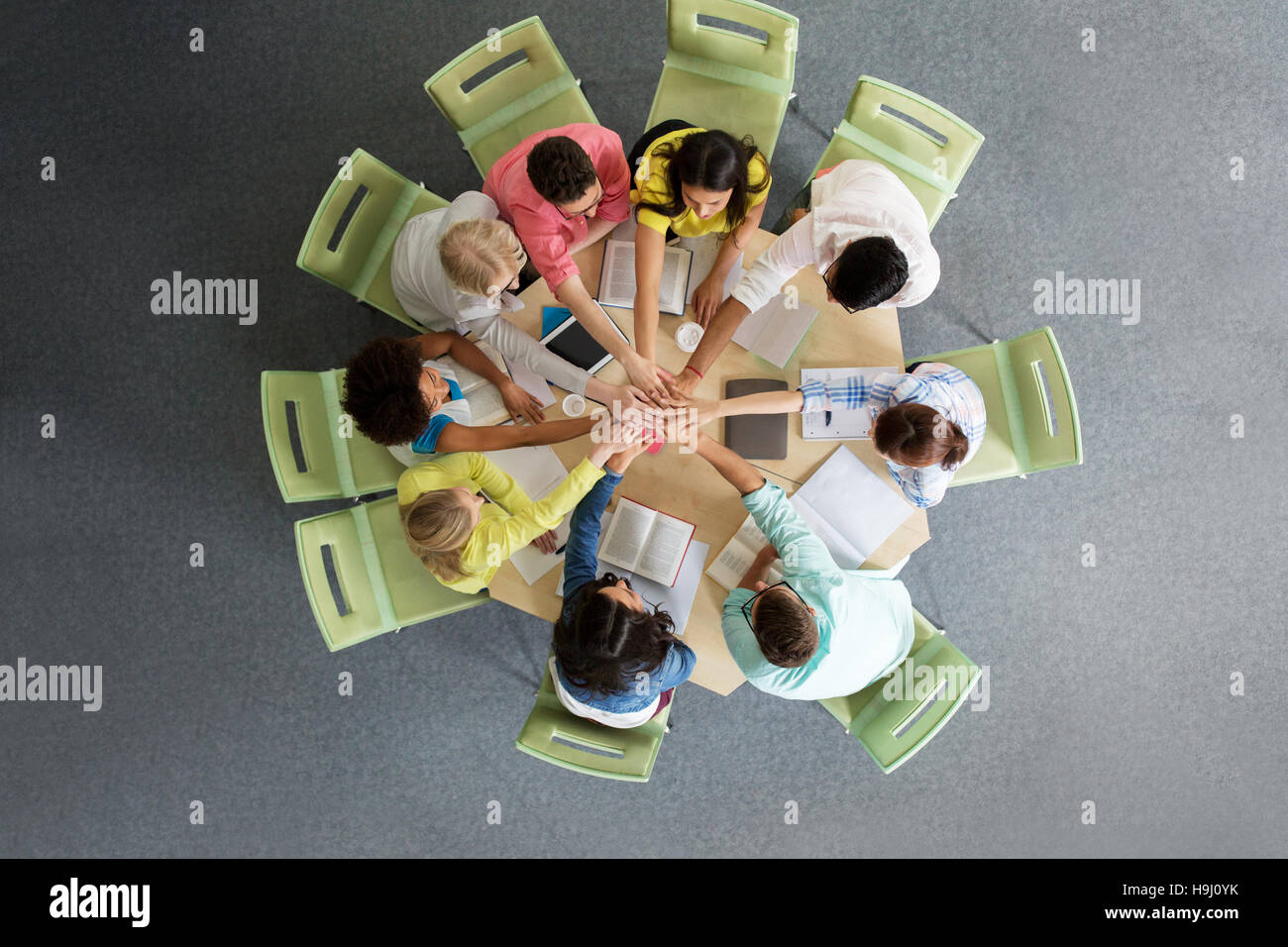 group of international students with hands on top Stock Photo - Alamy