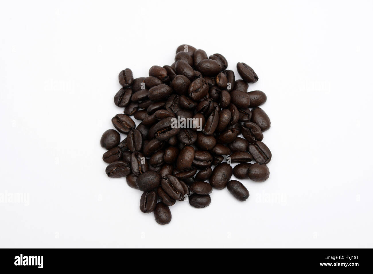 Pile of Roasted Coffee beans on white background Stock Photo - Alamy