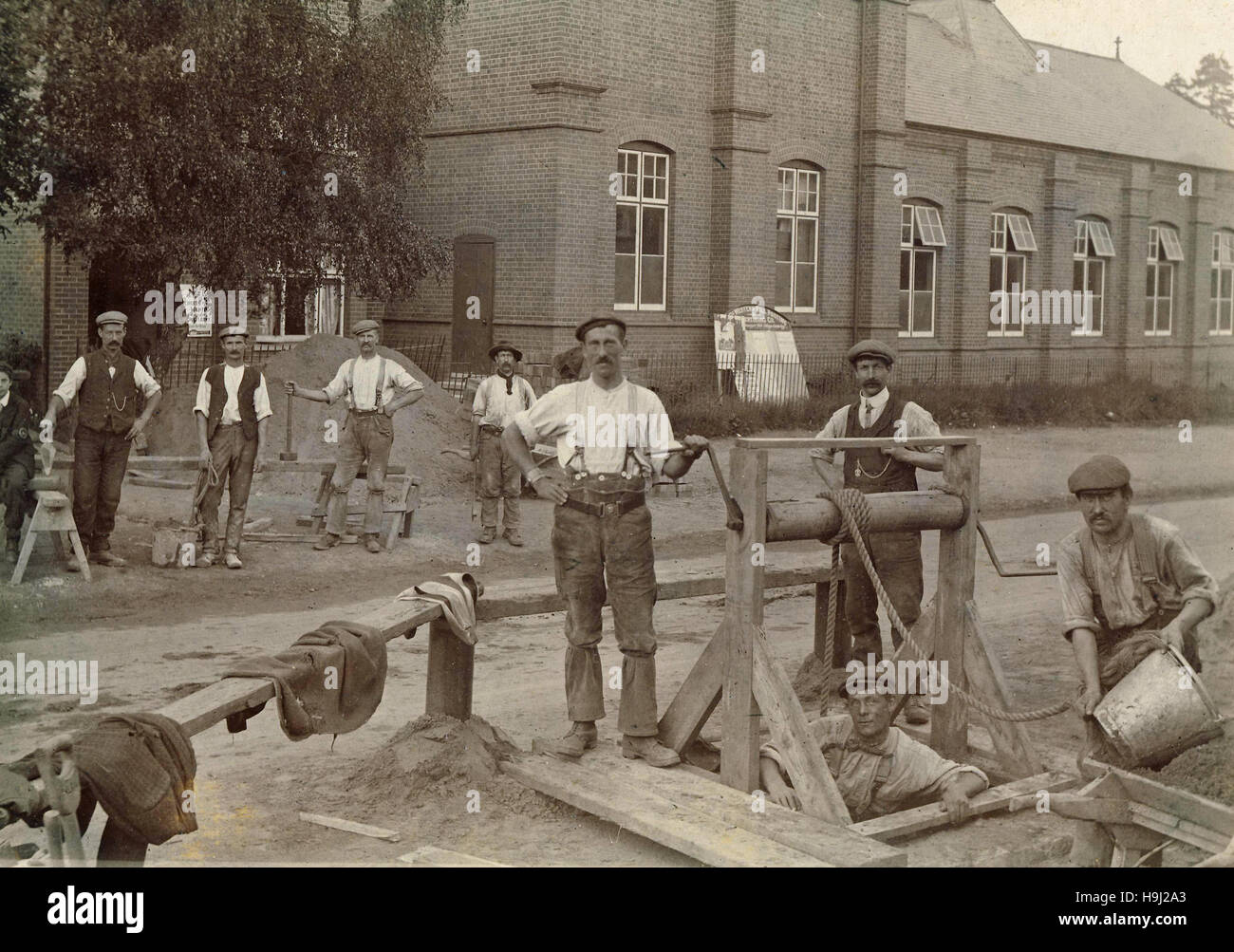 Historic archive image of men working in a hole in the road outside Farley Hill School in Berkshire c1900s Stock Photo
