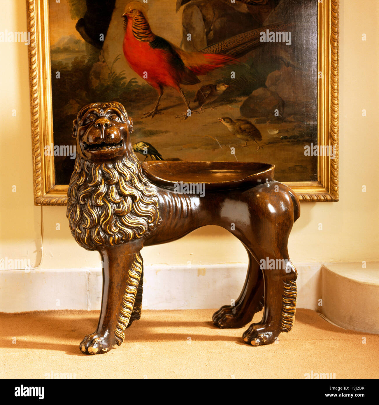 In the Lower Gallery, close-up view of the early nineteenth- century lion-shaped hall seat. Anglesey Abbey Stock Photo