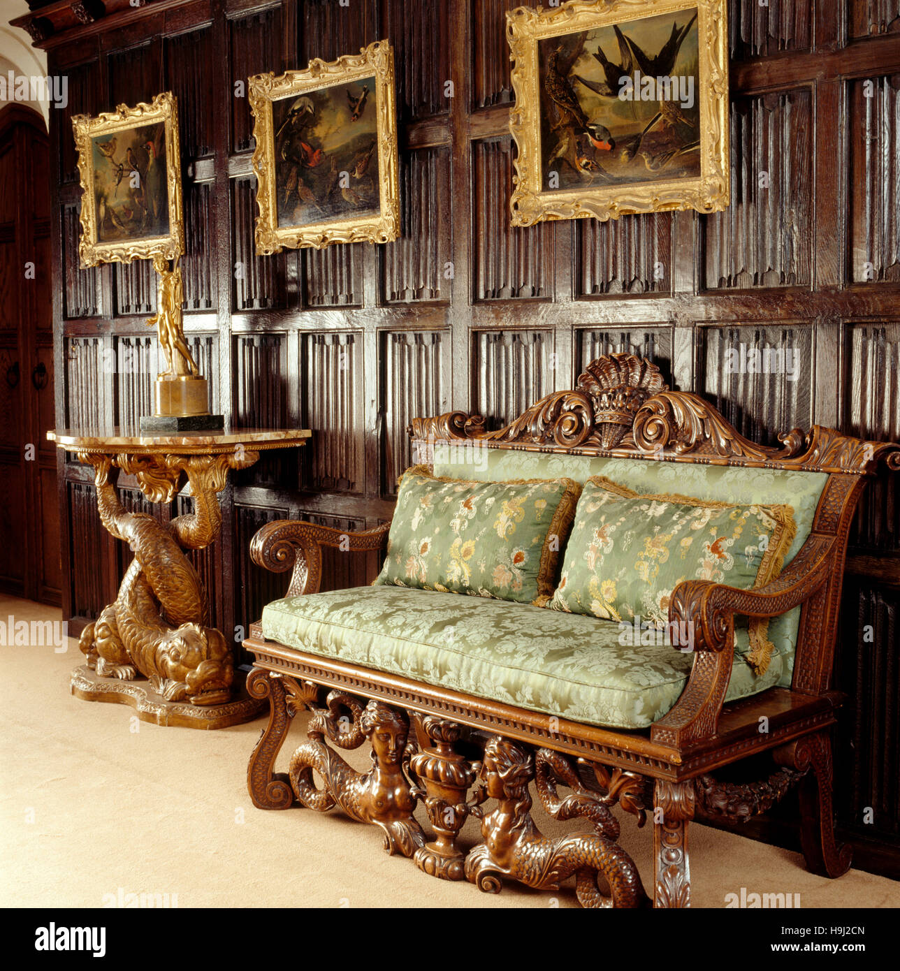 The Panelled Lobby. The walnut settee & gilt tables are in the style of the c18th designer William Kent. The dark oak linenfold panelling is four Stock Photo