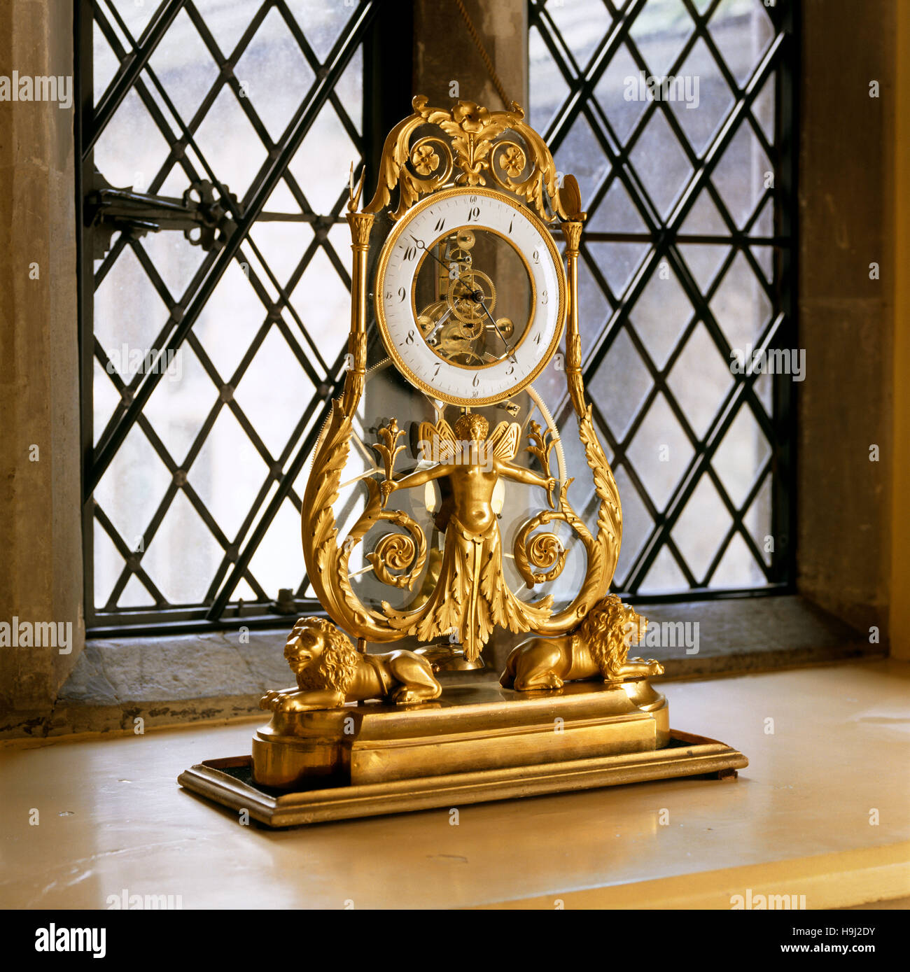 A French Empire 'skeleton' clock, c.1800, in the Windsor Corridor at Anglesey Abbey. Stock Photo