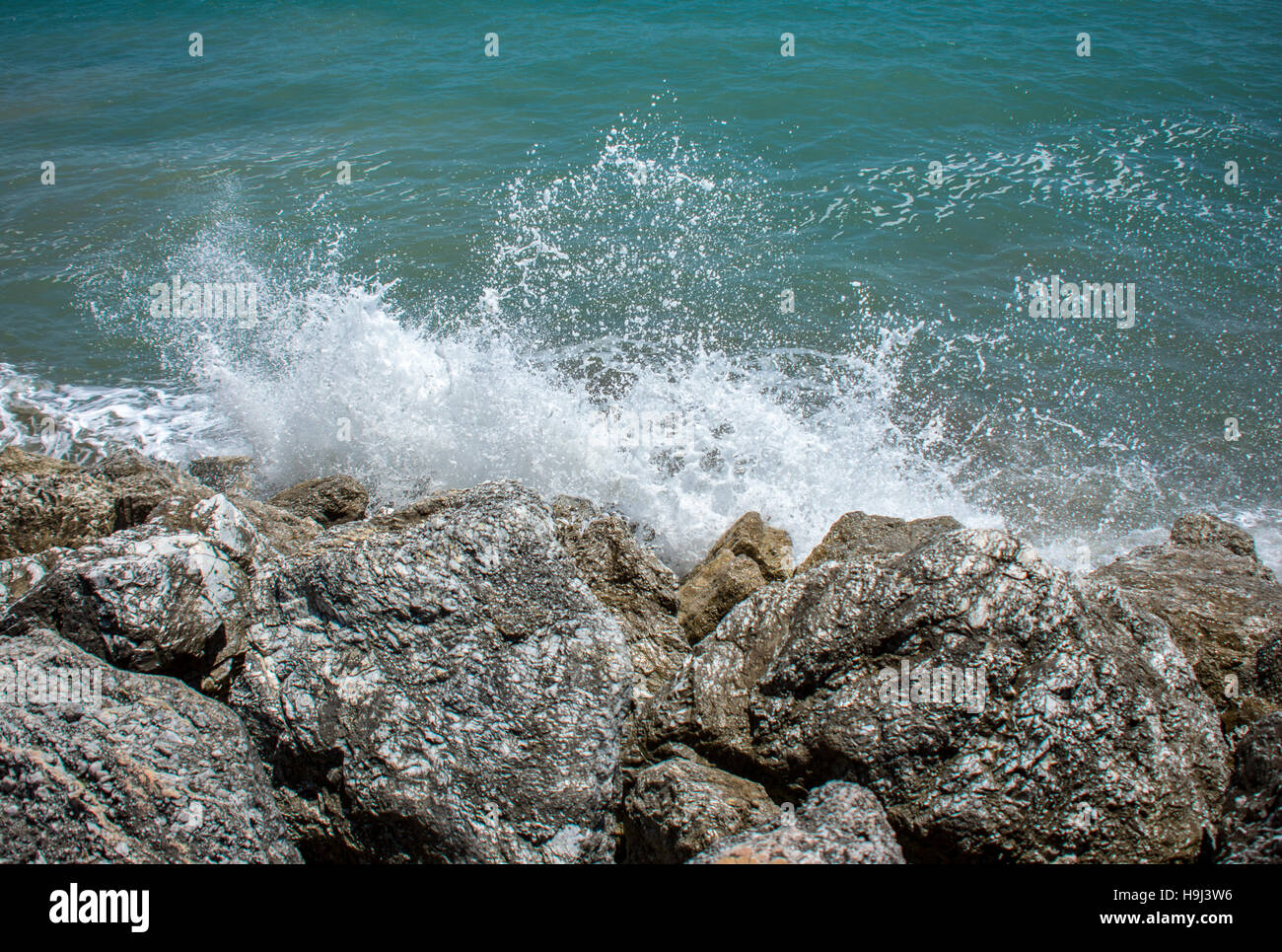 Waves crashing off coastal rocks in spain Stock Photo
