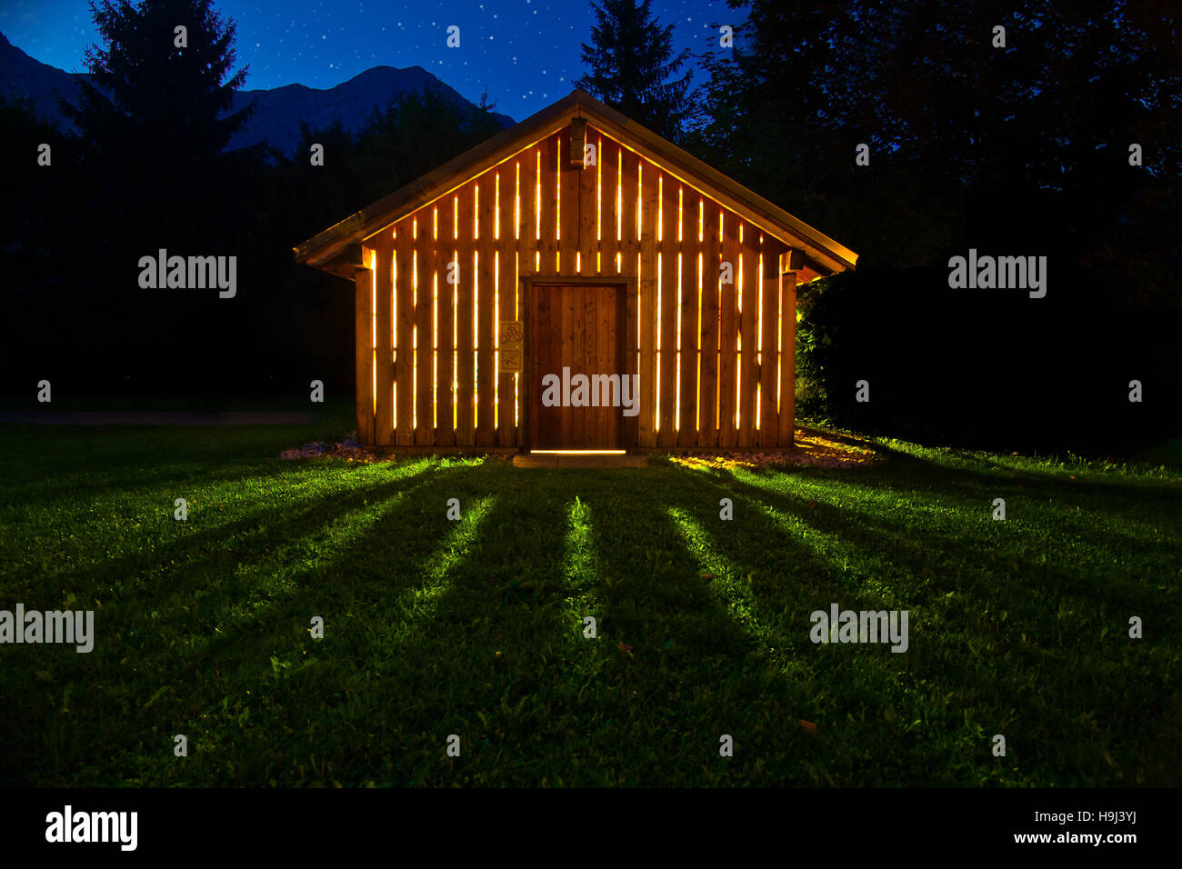 cottage in the night with lights under stars landscape mountains Stock ...