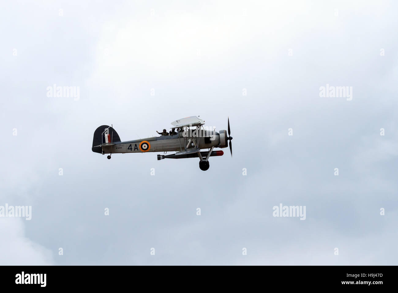 Royal Navy Fairey Swordfish biplane with air crew waving on flypast at the airshow Stock Photo