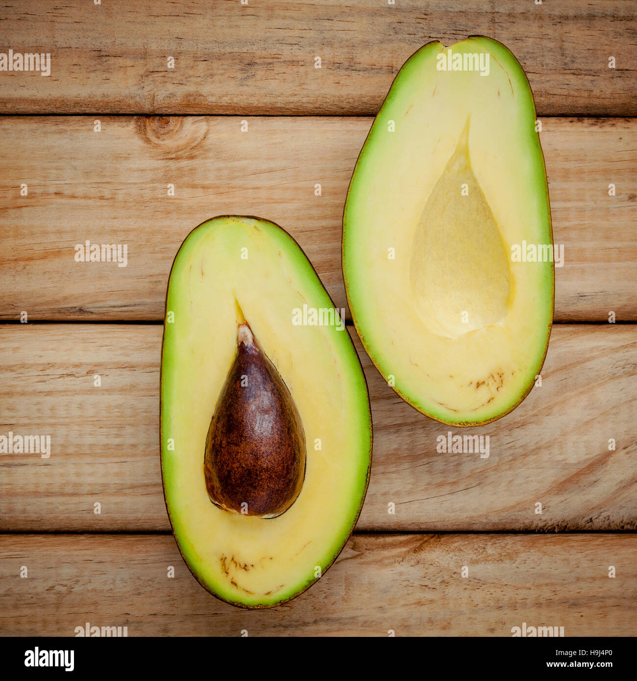 Fresh avocado on wooden background. Organic avocado healthy food Stock Photo
