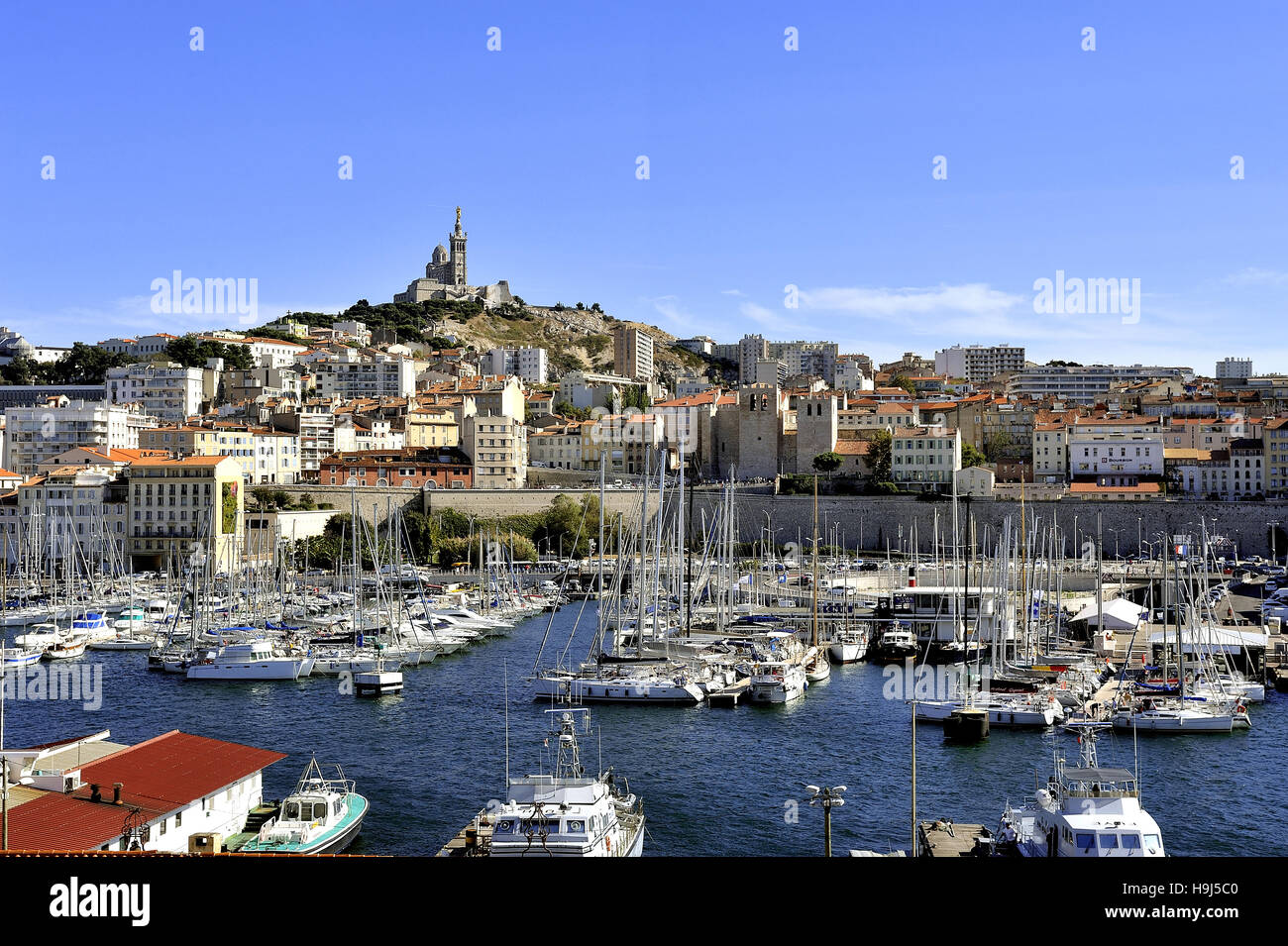 The famous old port of Marseille dominated by Notre Dame de la garde called here the Good Mother Stock Photo