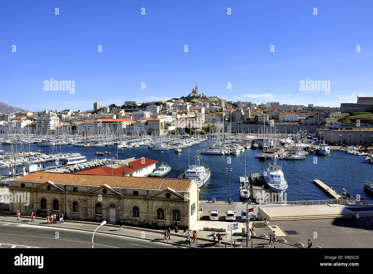 The famous old port of Marseille dominated by Notre Dame de la garde called here the Good Mother Stock Photo