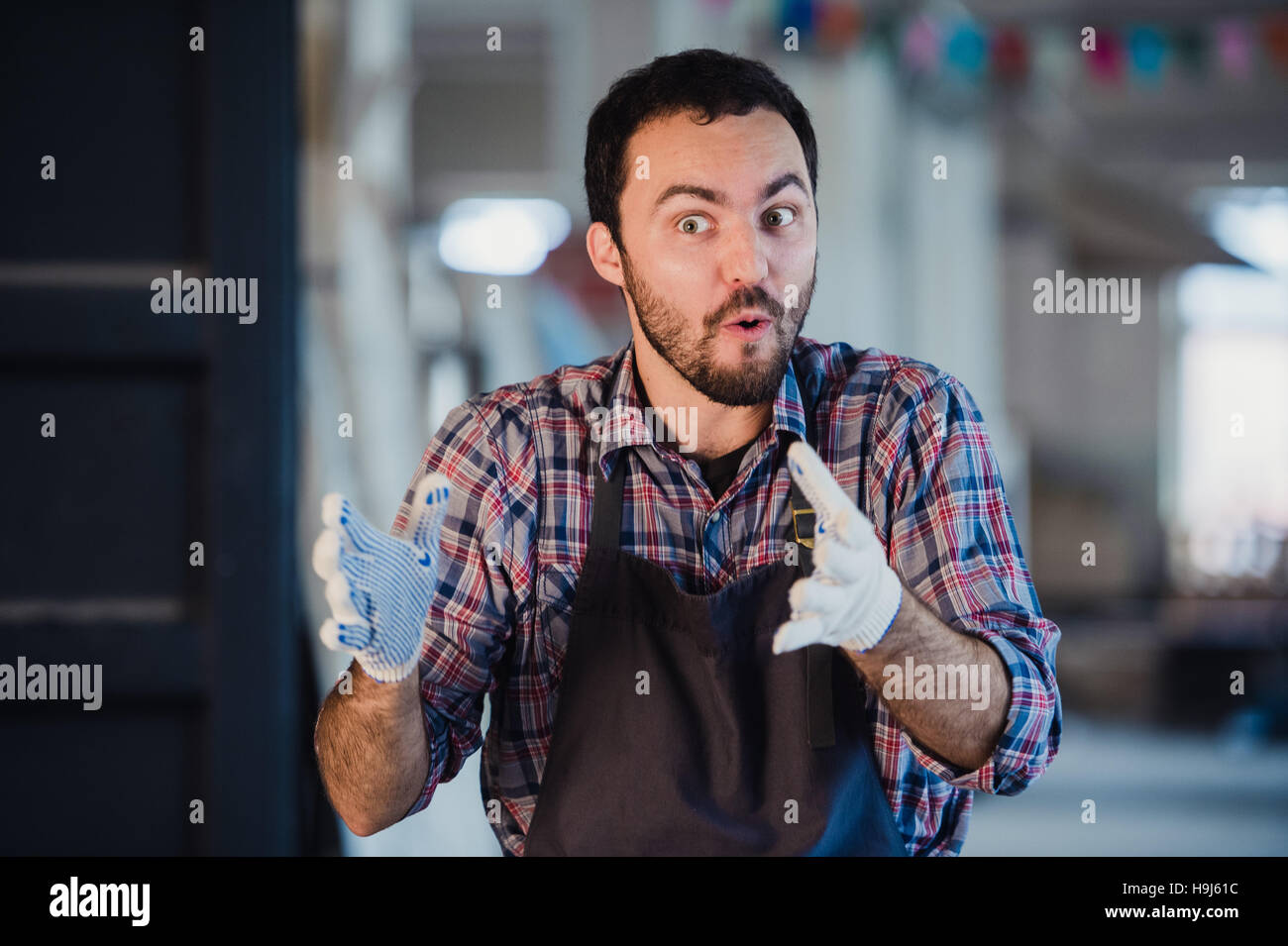 Worker show his finger in cloth glove explaining something to someone Stock Photo