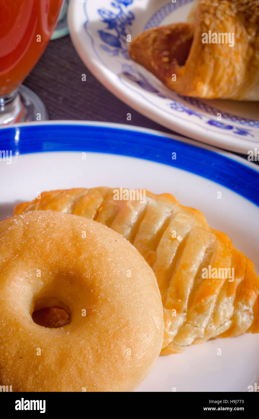 fragrant breakfast bagel, croissant, bagel, juice and milk illuminated