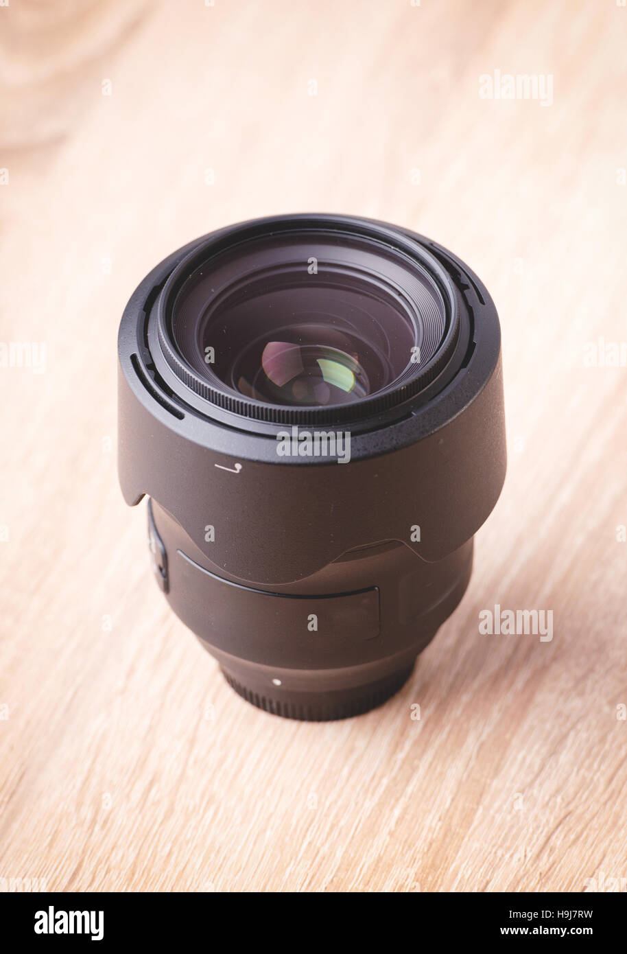 Camera lens at desk Stock Photo