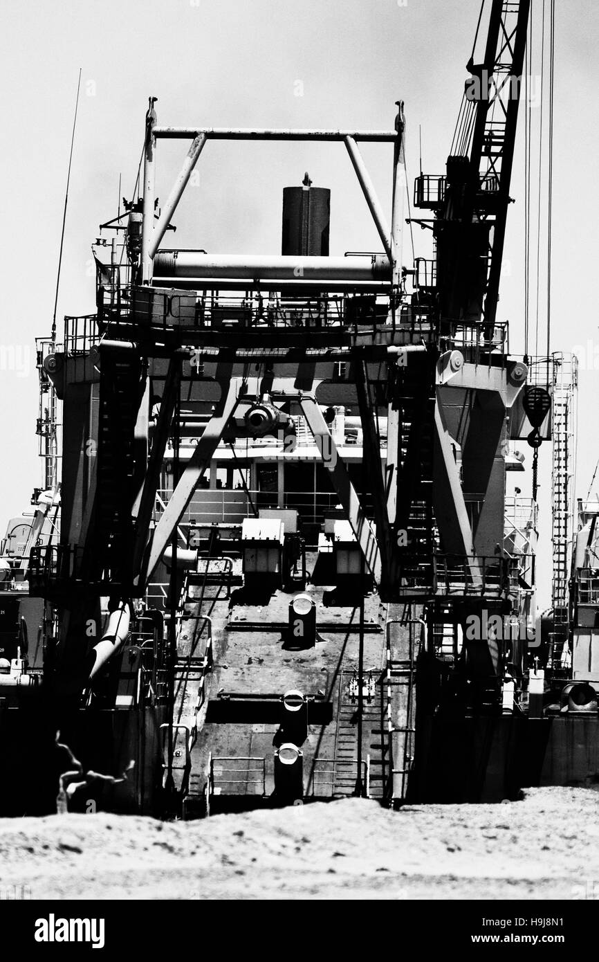Dredger ship next to shore in Açu port channel Stock Photo