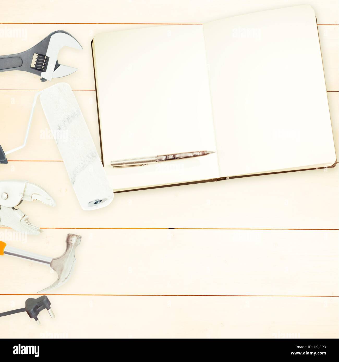 Tools and notepad on wooden background Stock Photo - Alamy