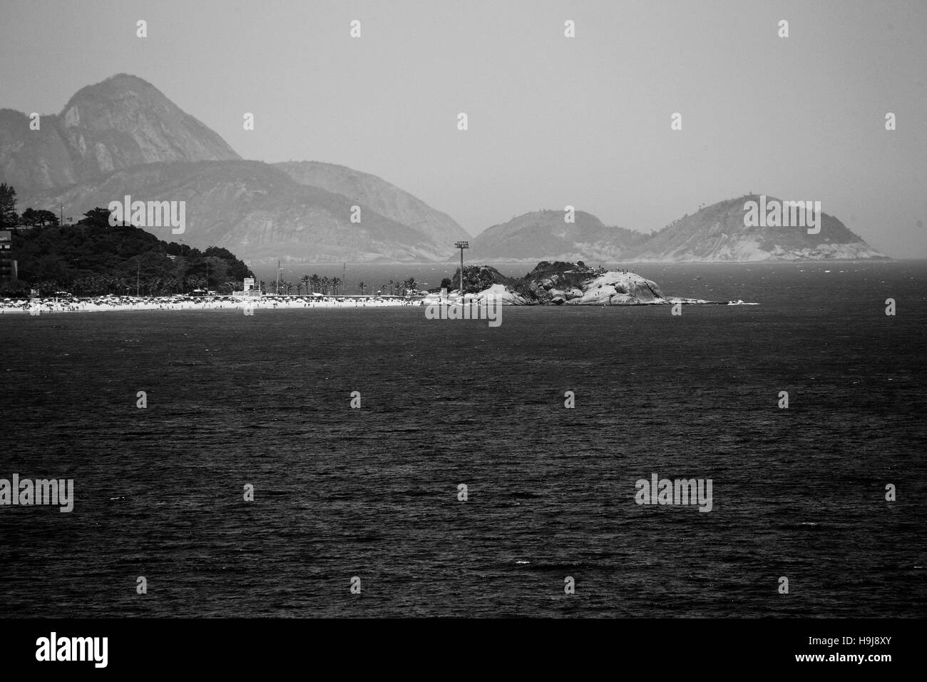 Arpoador Point with mountains and islands in the background Stock Photo