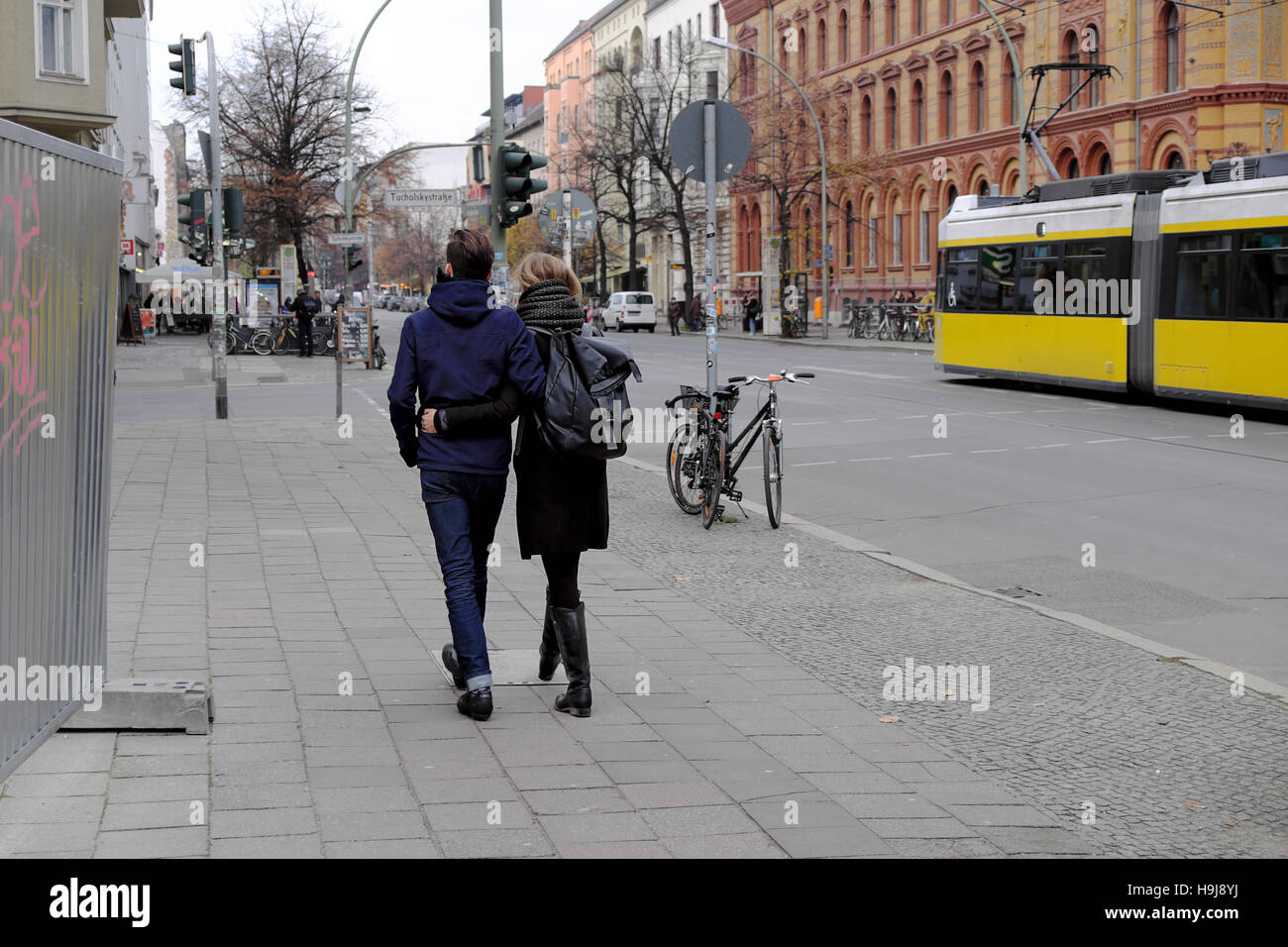 A young couple walking along Oranienburger Strasse with tram in Berlin November 2016 Germany, Europe  KATHY DEWITT Stock Photo