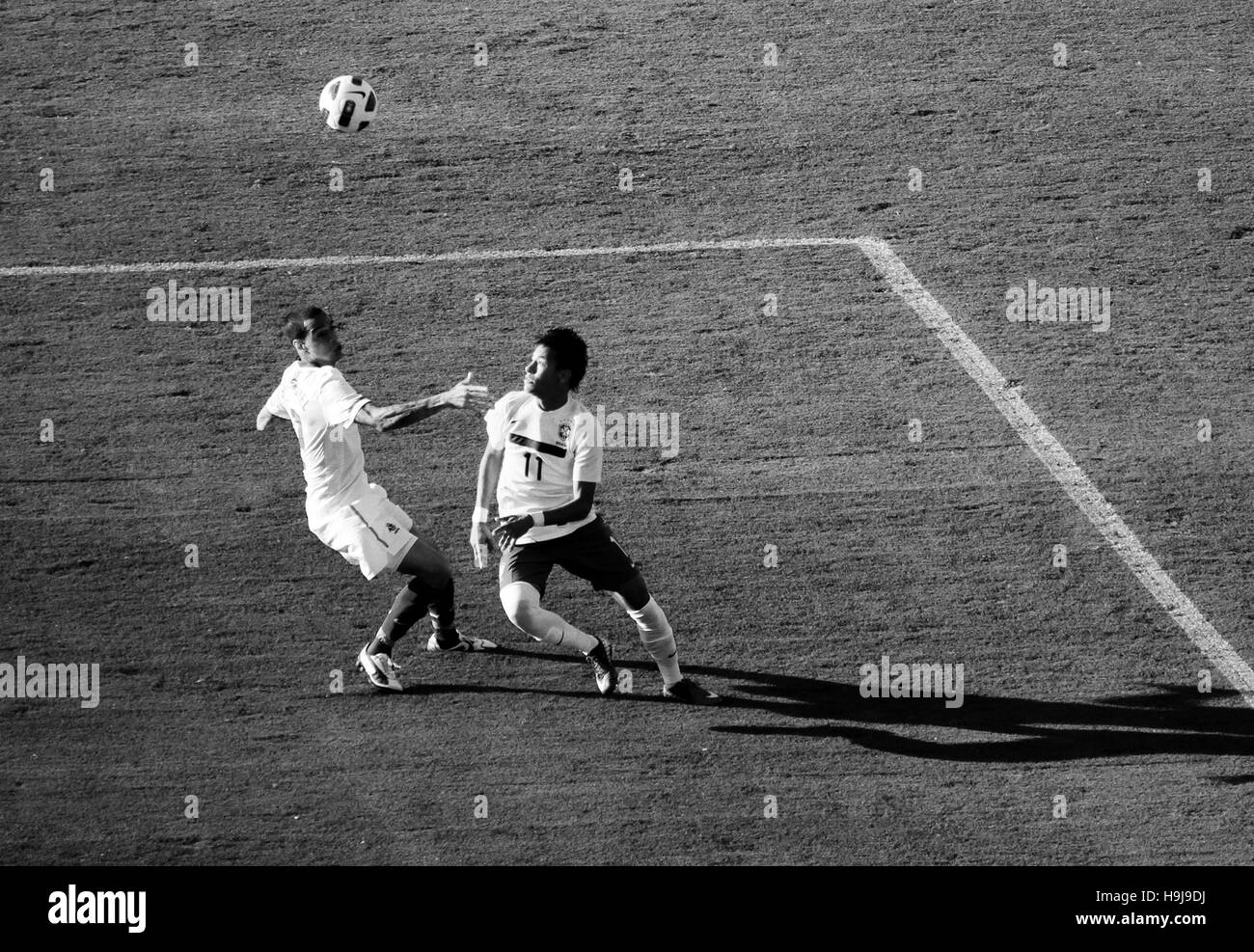 Soccer player Neymar floating the ball over another player Stock Photo