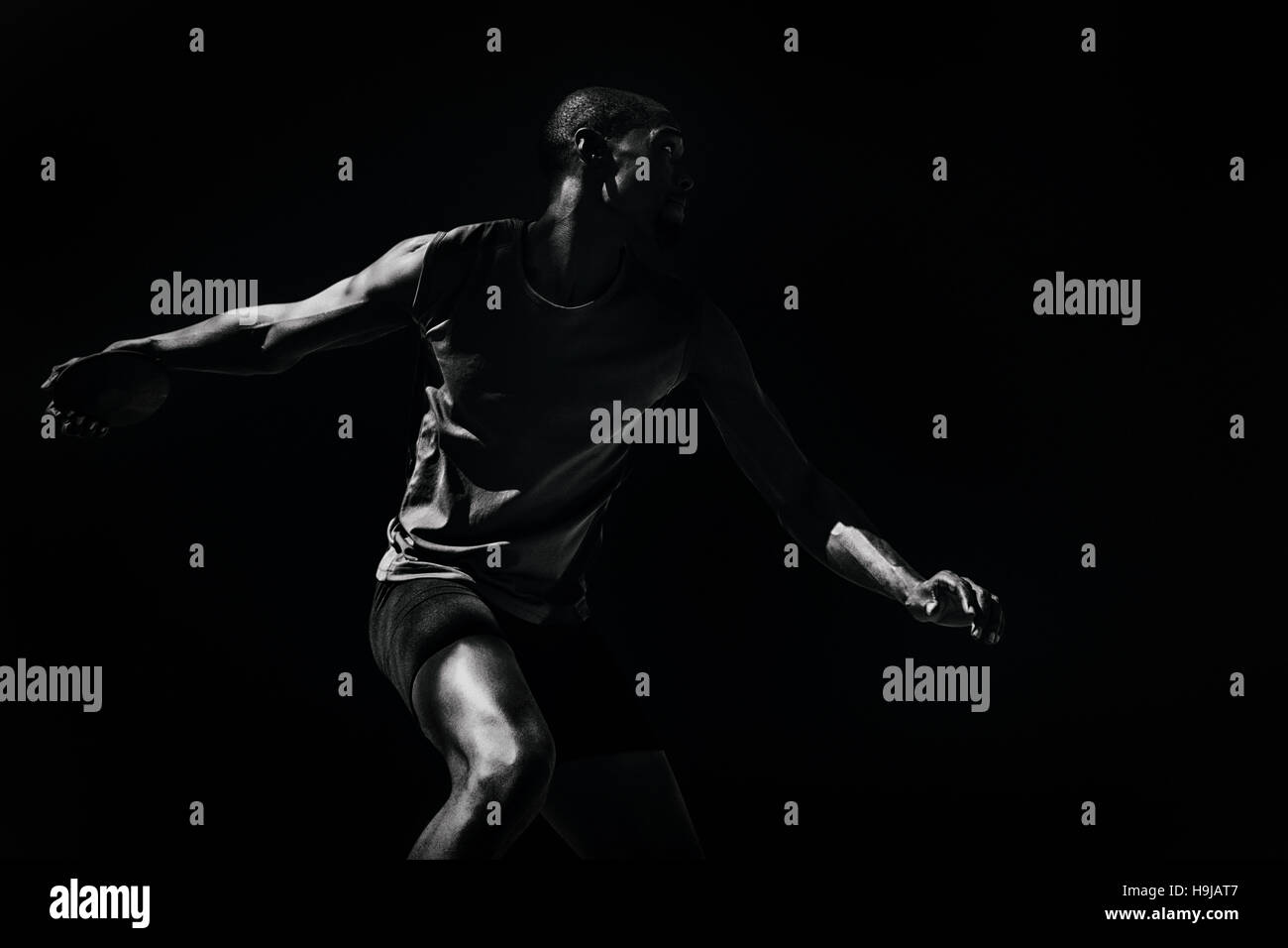 Composite image of athlete man throwing a discus Stock Photo