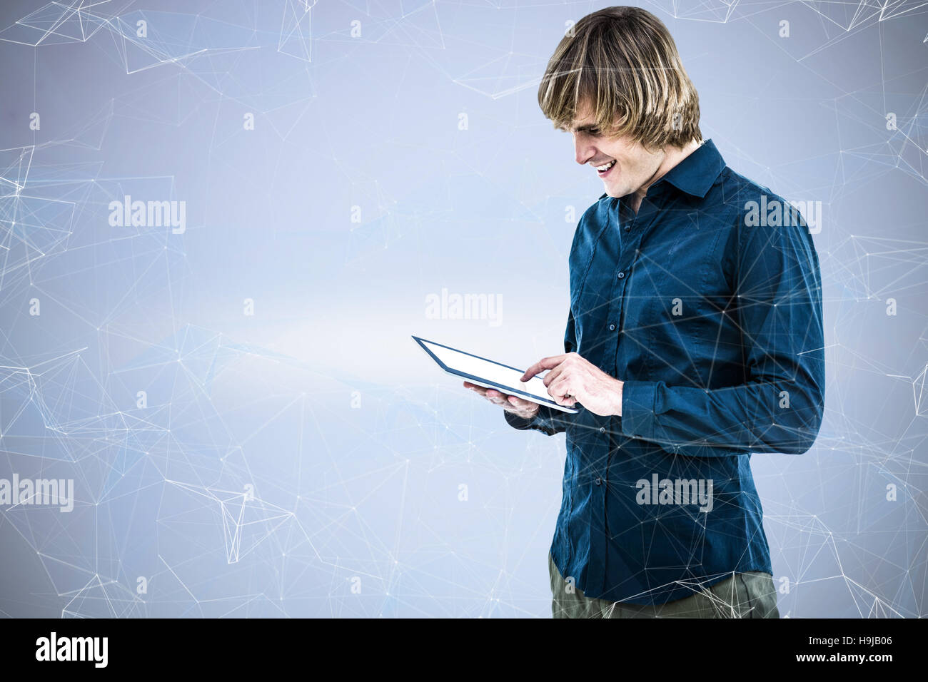 Composite image of hipster businessman using tablet Stock Photo