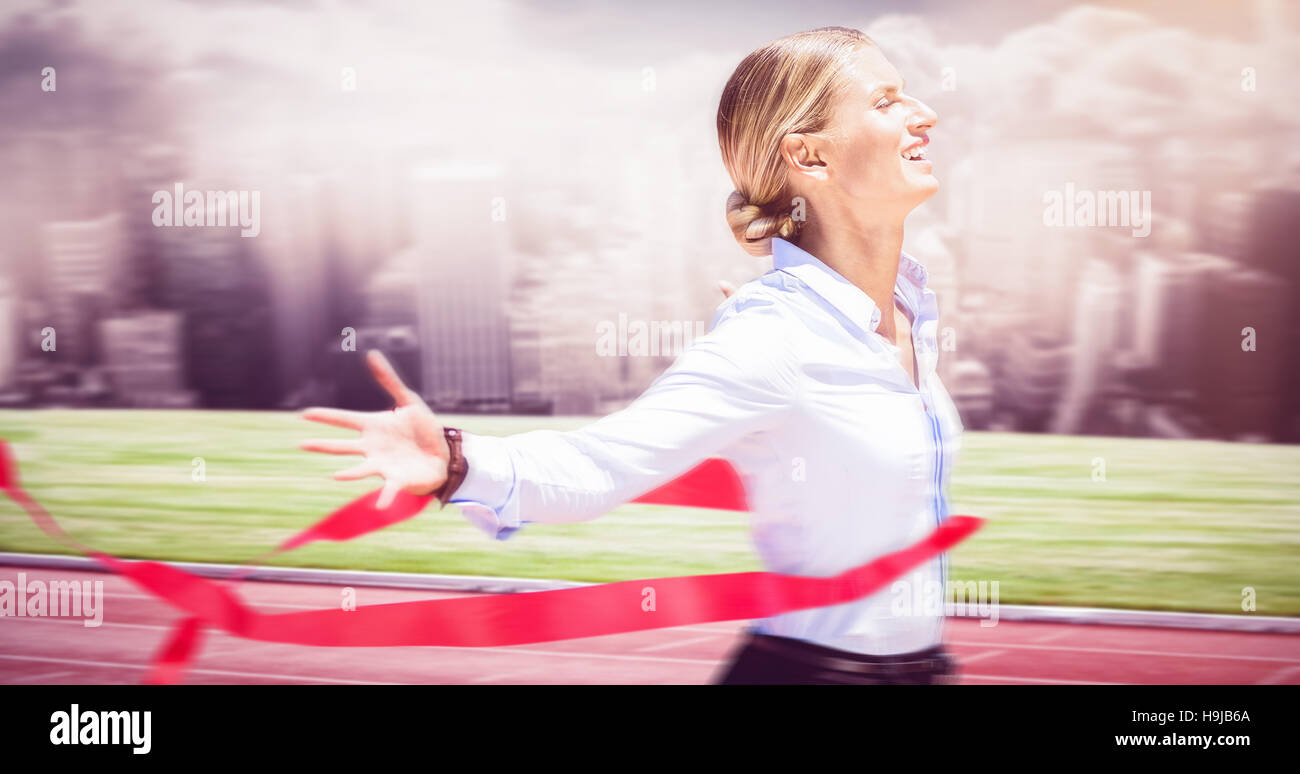 Composite image of successful businesswoman raising arms Stock Photo