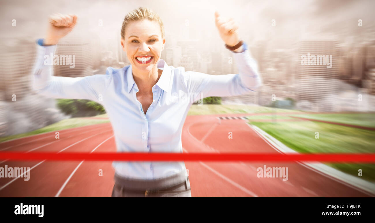 Composite image of successful businesswoman raising arms Stock Photo