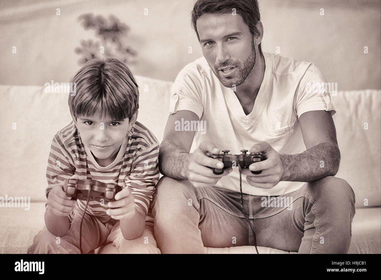 Father and son playing video games Stock Photo Alamy