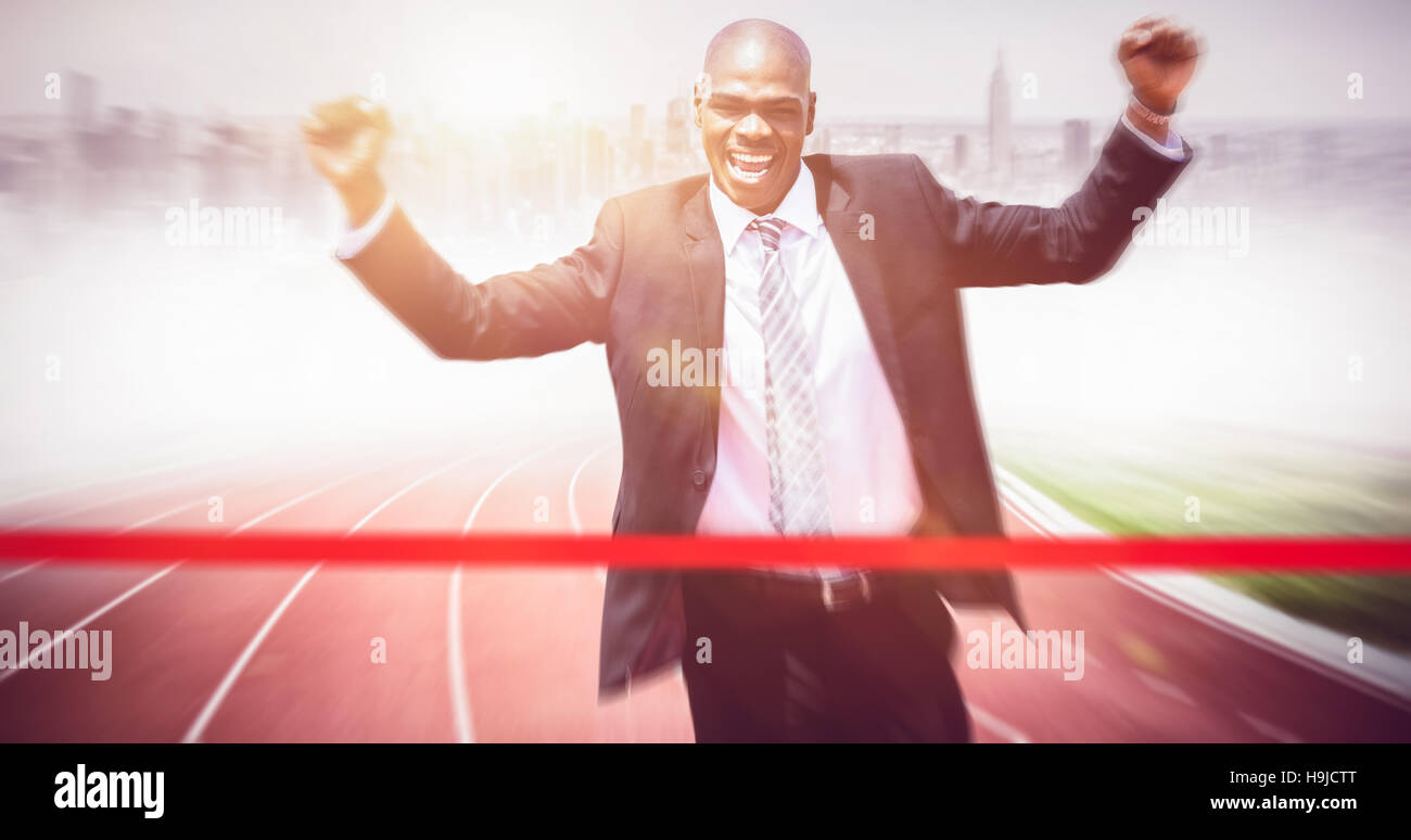 Composite image of successful businessman raising arms Stock Photo - Alamy