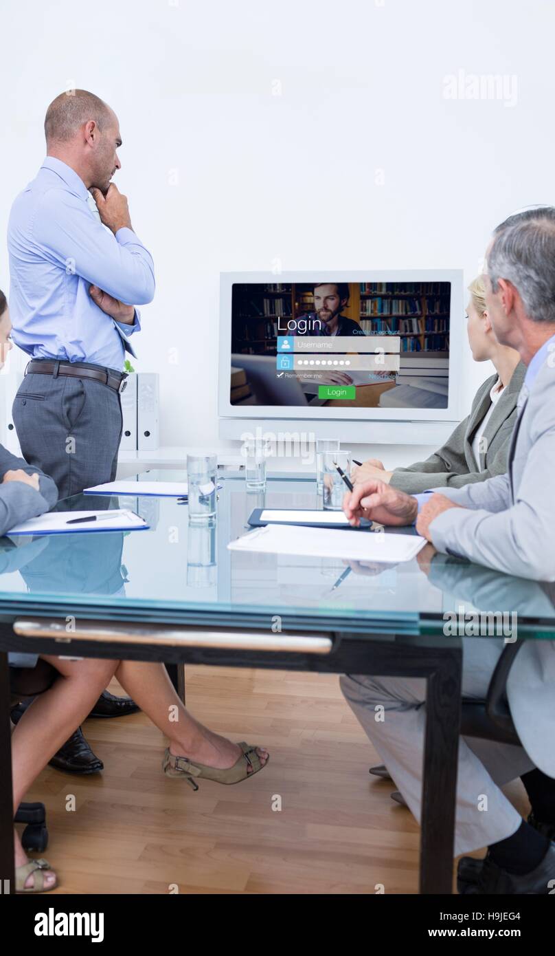 Composite image of business team looking at white screen Stock Photo ...