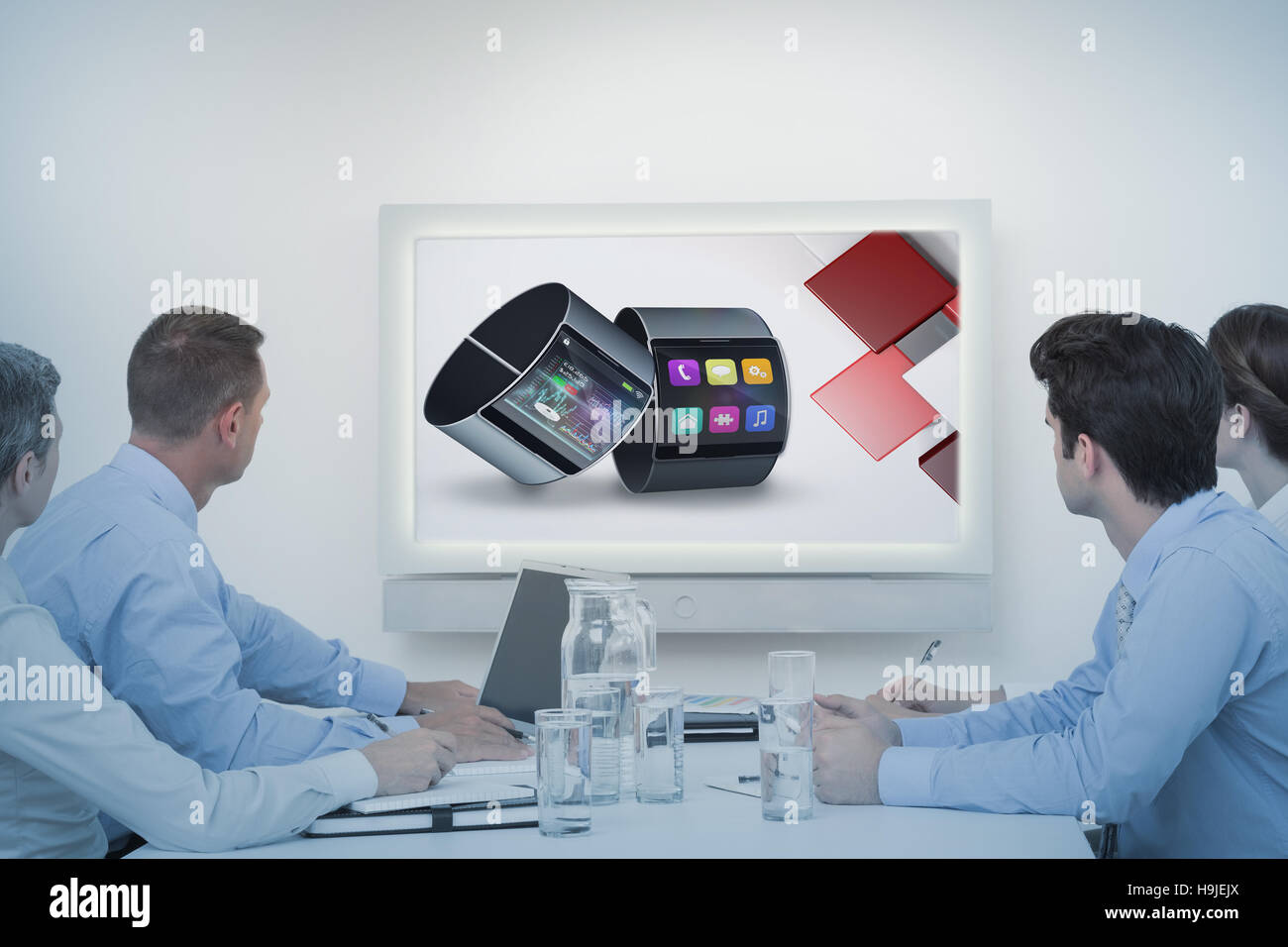 Composite image of business team watching whiteboard during a meeting