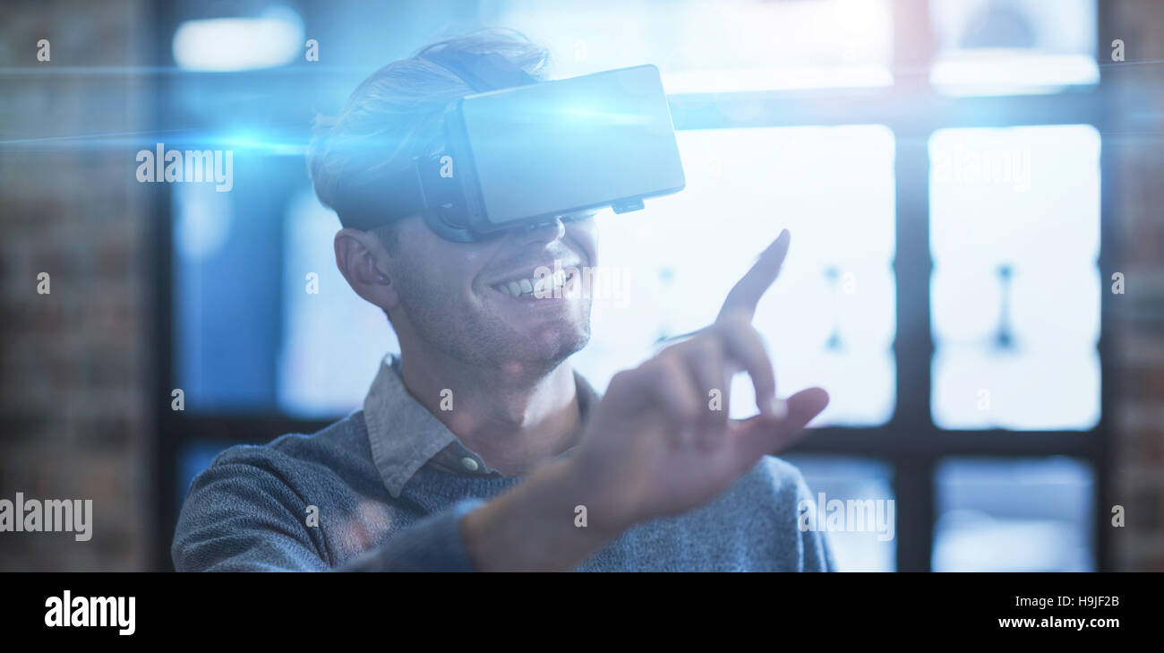 Businessman using virtual reality headset in office Stock Photo - Alamy