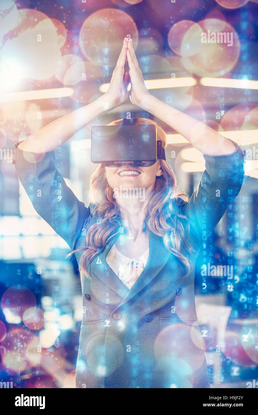Businesswoman with hands joined using virtual reality simulator Stock Photo