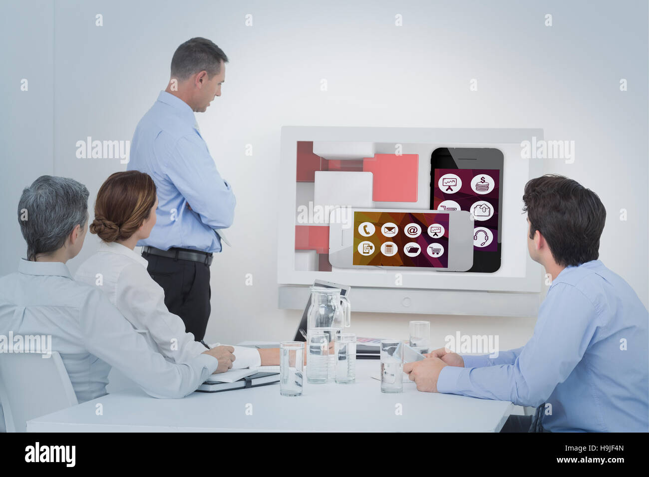 Composite image of business team looking screen Stock Photo - Alamy