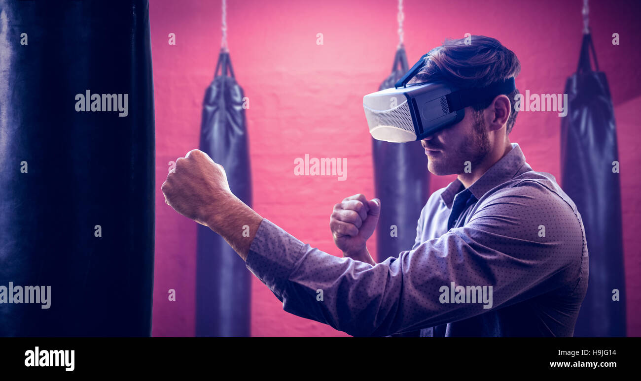 Composite image of man using an oculus and fighting Stock Photo