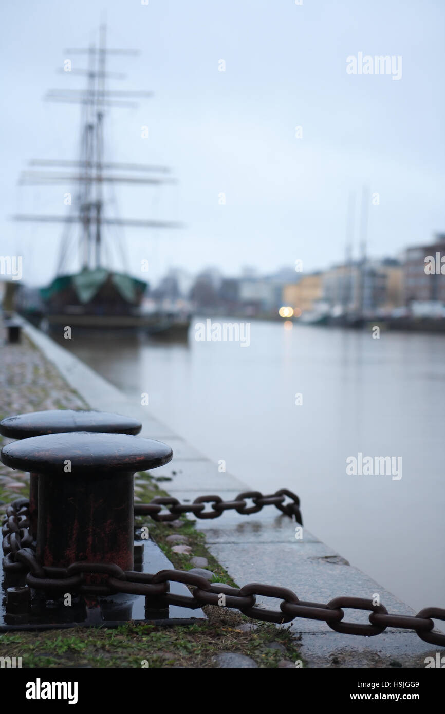 Nice sailing ship near granite embankment. Evening in Turku, Finland