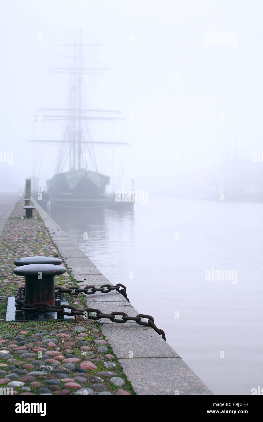 Big sailing ship near granite embankment in morning fog Stock Photo Alamy