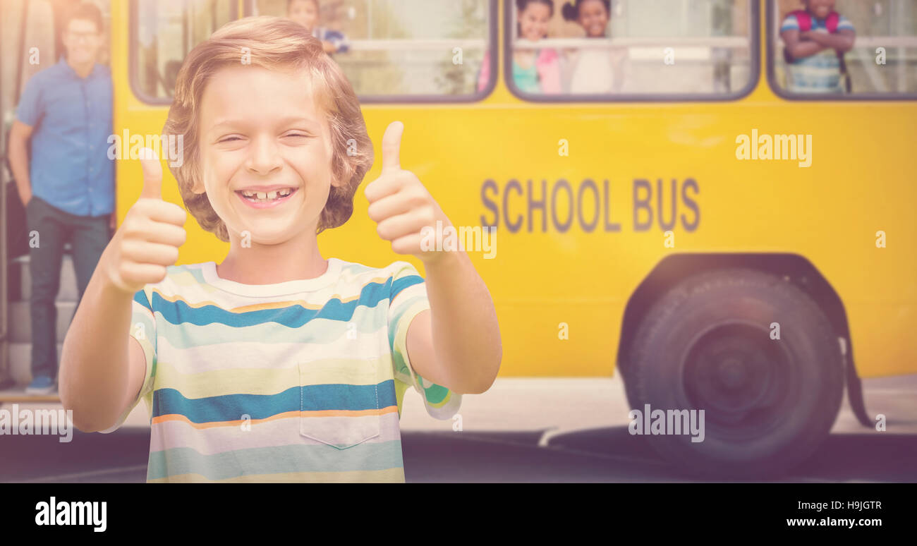 Composite image of boy showing thumbs up while smiling Stock Photo - Alamy