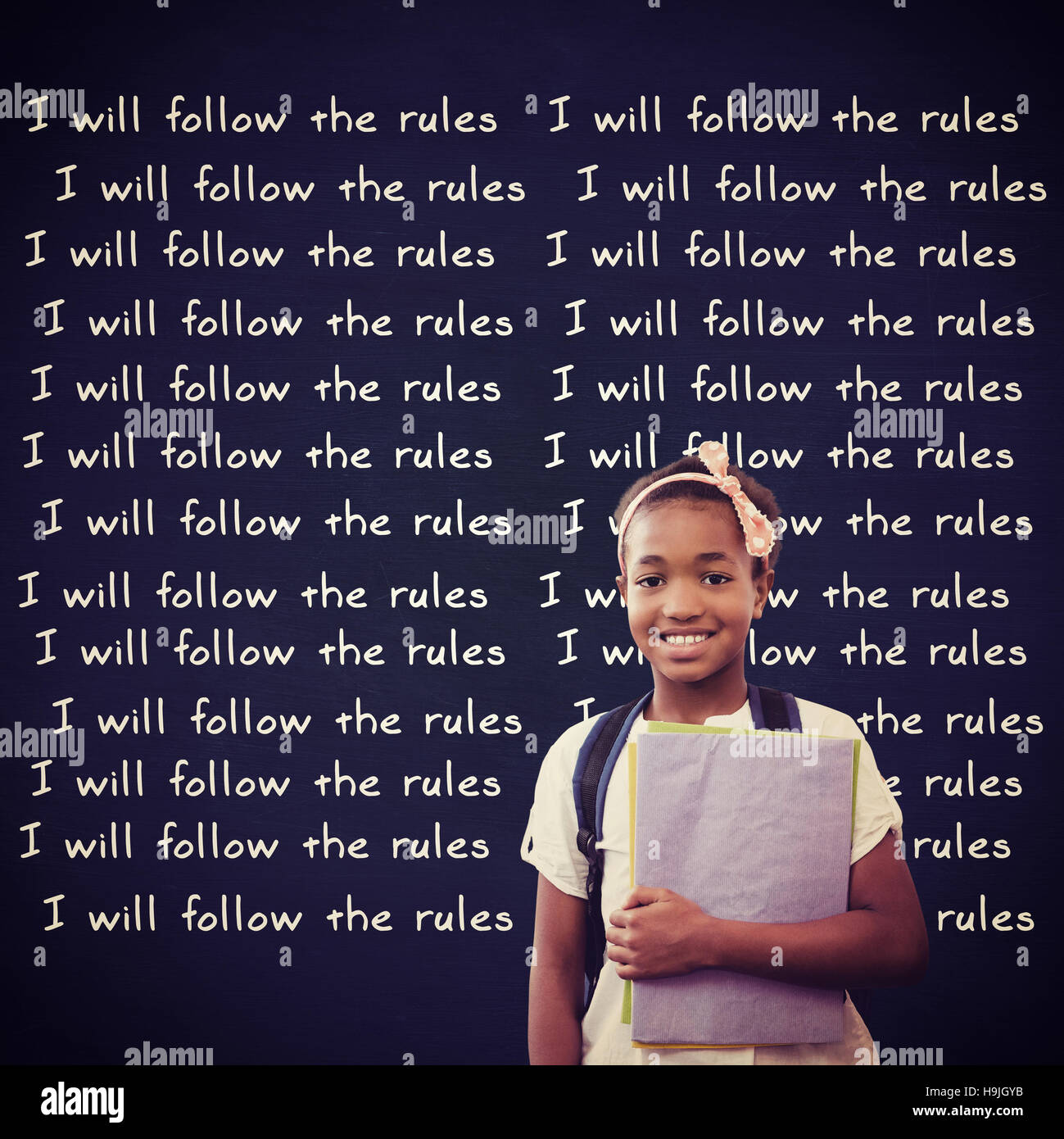 Composite image of little girl holding folders in school corridor Stock Photo